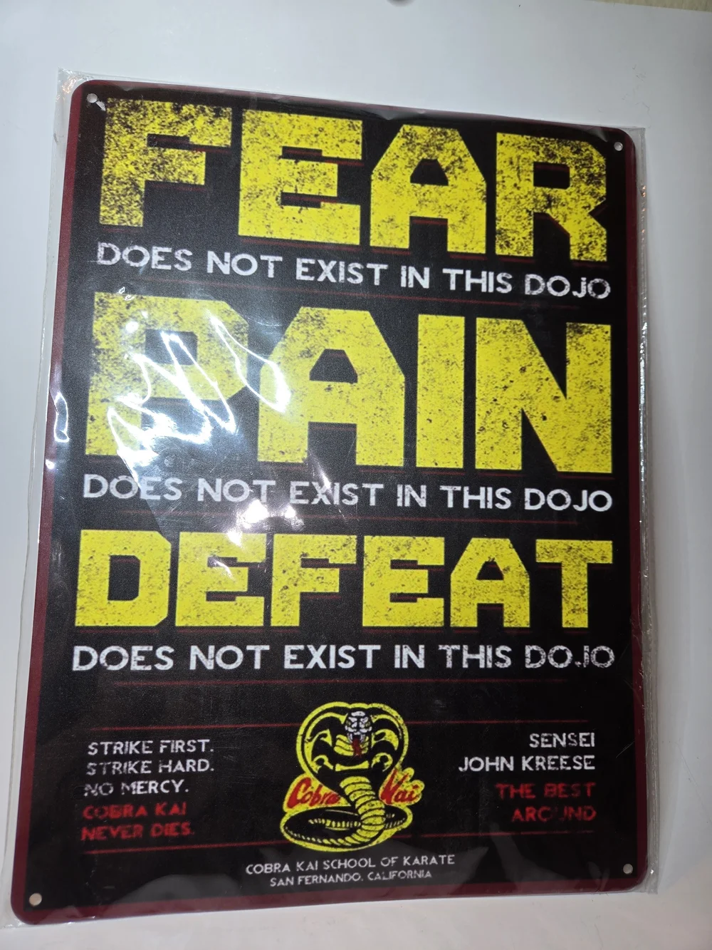 Cobra Kai Metal Sign featuring iconic mottos and the dojo logo as on the TV Show